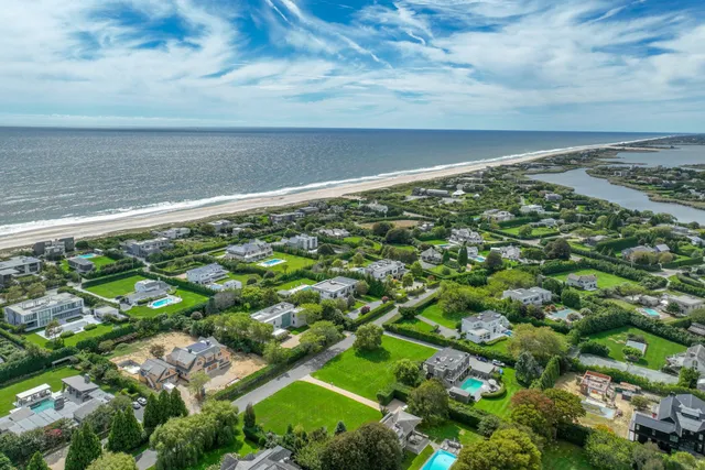 a view of a field of grass and trees
