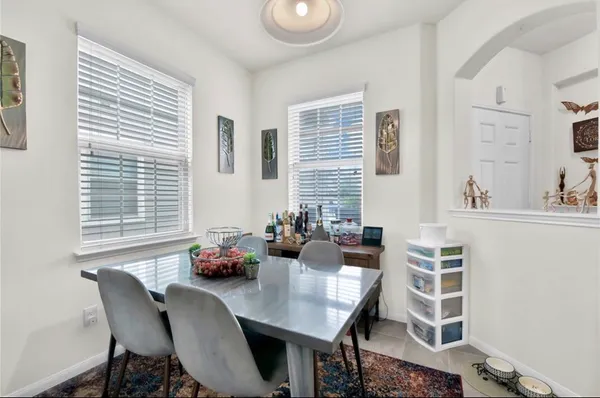 a dining room with furniture and window