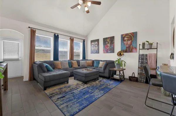 a living room with furniture and a chandelier