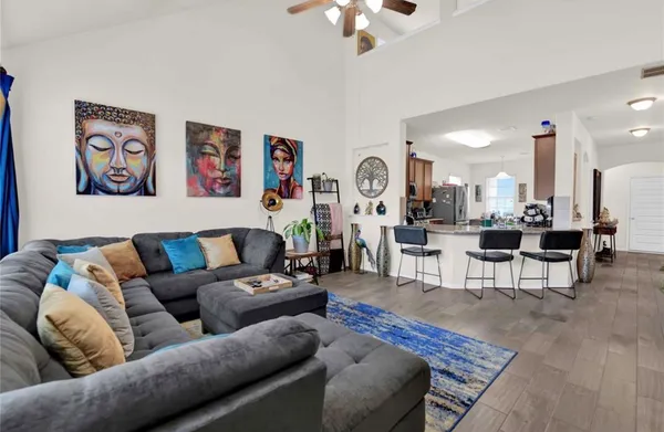 a living room with furniture and kitchen view