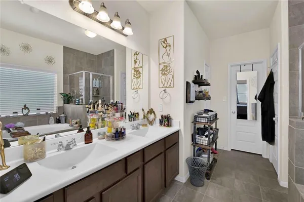 a bathroom with a sink double vanity and a mirror