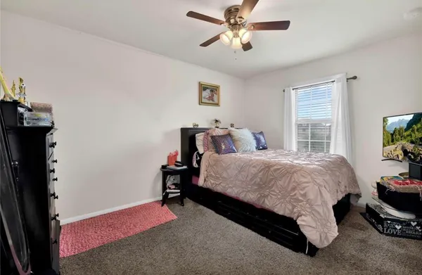 a spacious bedroom with a bed and a window