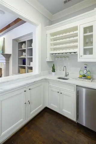 a white kitchen with sink and window