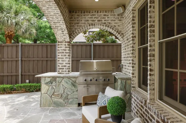a view of a patio with table and chairs potted plants