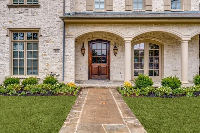 a front view of a house with a garden