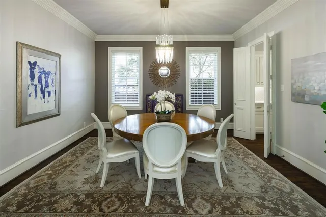 a dining room with furniture wooden floor a rug and a painting
