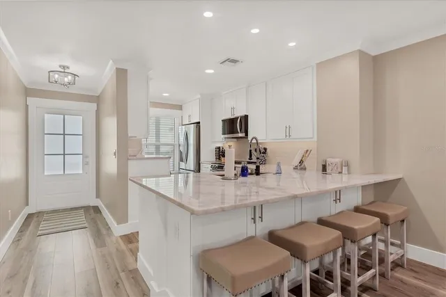 a large kitchen with a table and chairs in it