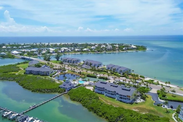 an aerial view of a houses with ocean view