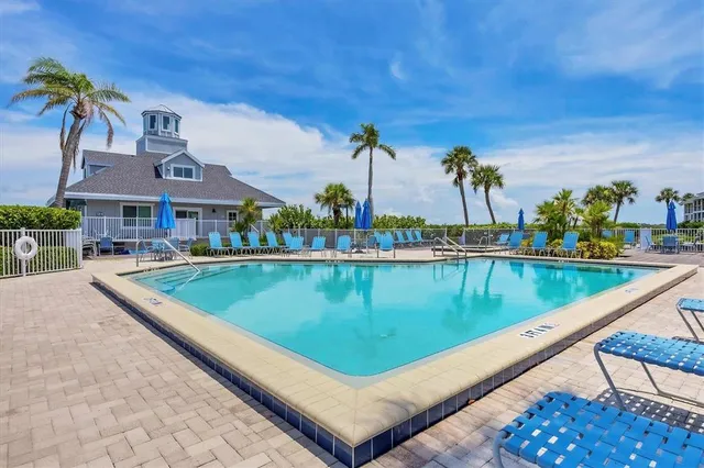 a view of swimming pool with a table and chairs