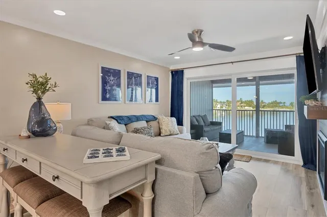a living room with furniture and a floor to ceiling window