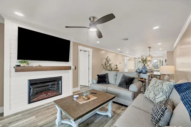 a living room with furniture a fireplace and a flat screen tv