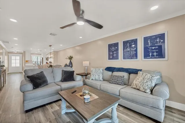 a living room with furniture and kitchen view