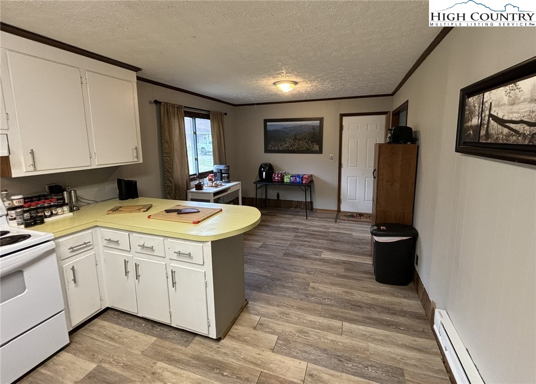 224 Alex Wellborn Road Deep Gap, NC 28618 - Photo 12 of 26 a view of a kitchen with sink and refrigerator