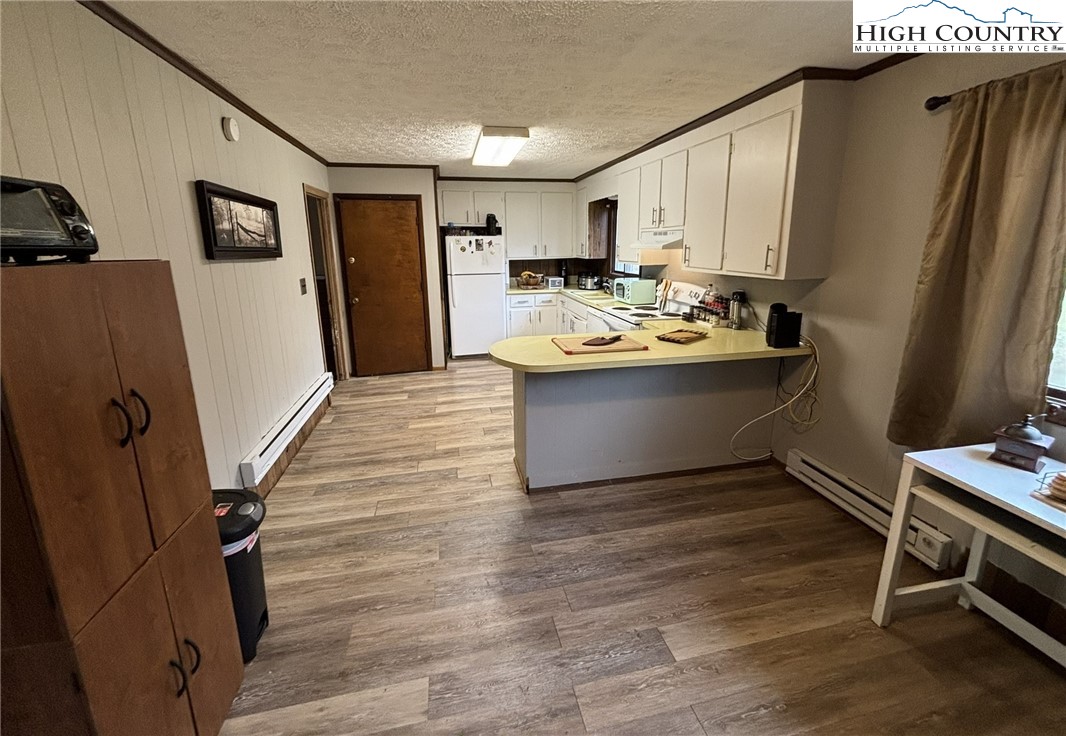 224 Alex Wellborn Road Deep Gap, NC 28618 - Photo 14 of 26 a view of kitchen with wooden floor and electronic appliances