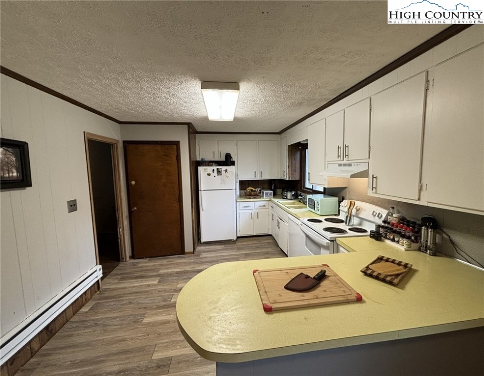 224 Alex Wellborn Road Deep Gap, NC 28618 - Photo 15 of 26 a kitchen with sink refrigerator and cabinets