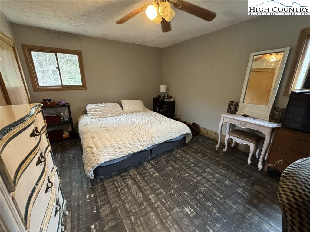 224 Alex Wellborn Road Deep Gap, NC 28618 - Photo 16 of 26 a bedroom with a bed and a chandelier