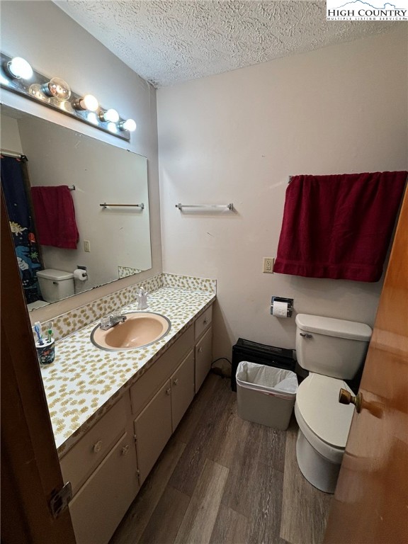 224 Alex Wellborn Road Deep Gap, NC 28618 - Photo 23 of 26 a bathroom with a granite countertop toilet sink and mirror
