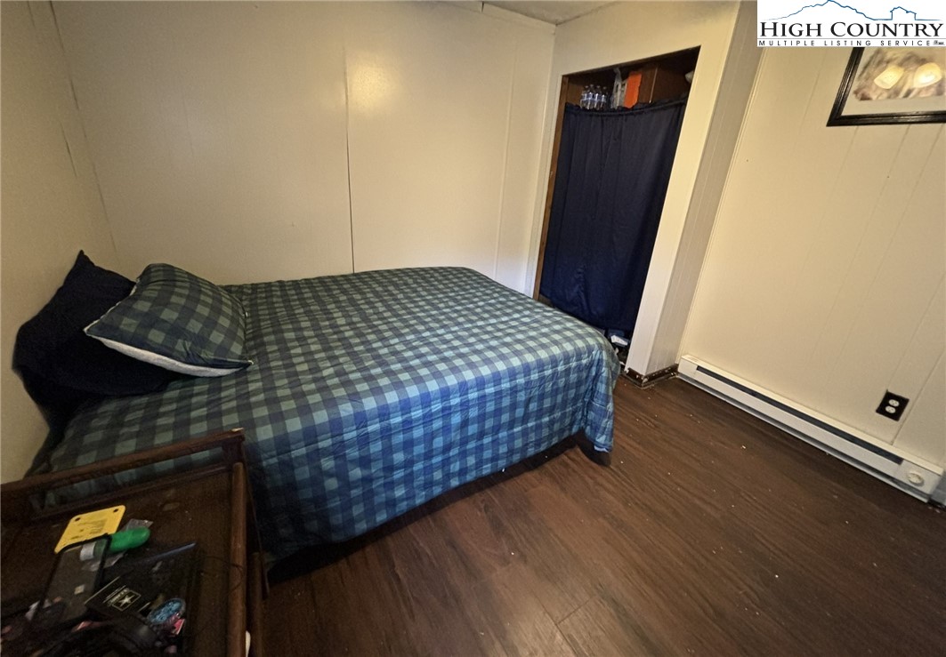 224 Alex Wellborn Road Deep Gap, NC 28618 - Photo 24 of 26 a bedroom with bed and wooden floor