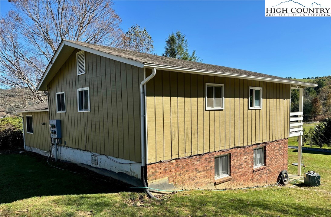224 Alex Wellborn Road Deep Gap, NC 28618 - Photo 5 of 26 a front view of a house with a yard