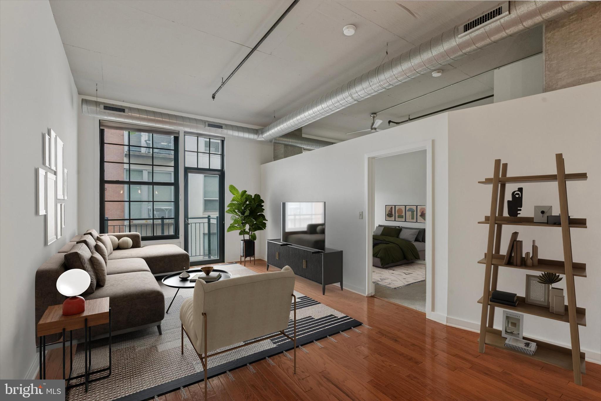 a living room with furniture and a floor to ceiling window