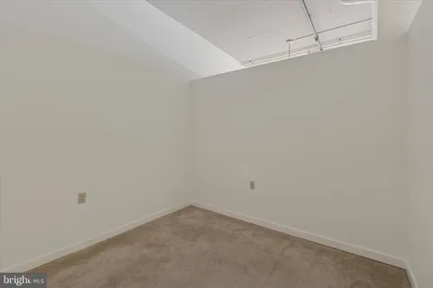 a view of a building with potted plants and more windows