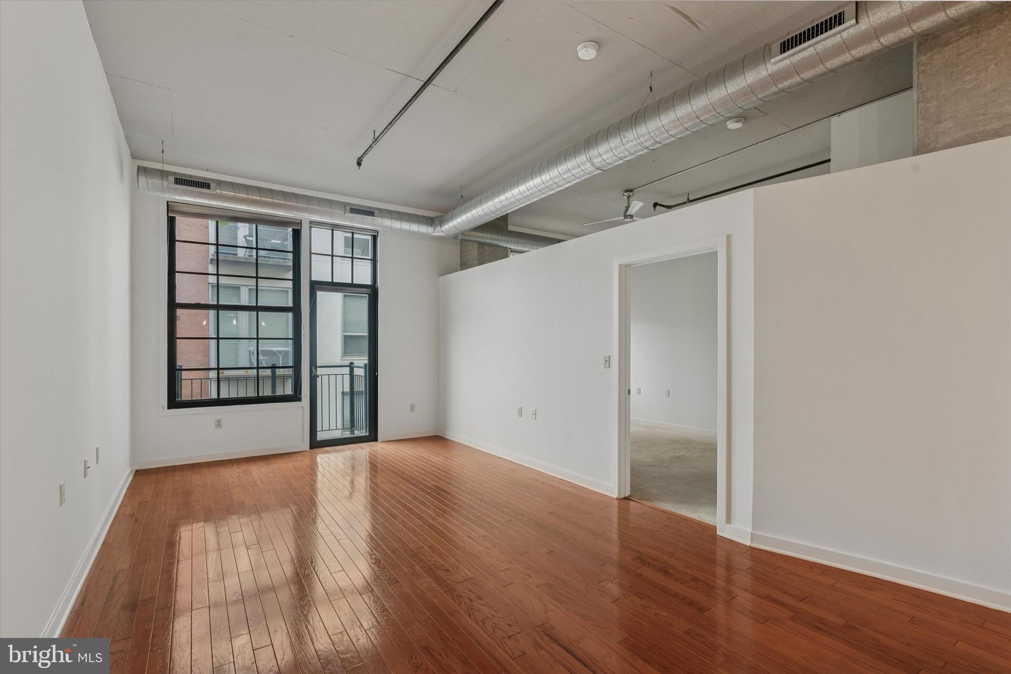 112 North 2nd Street, Unit 5F5 Philadelphia, PA 19106 - Photo 3 of 16 a view of an empty room with wooden floor and a window