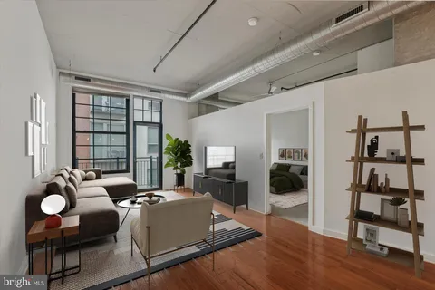 a living room with furniture and a floor to ceiling window
