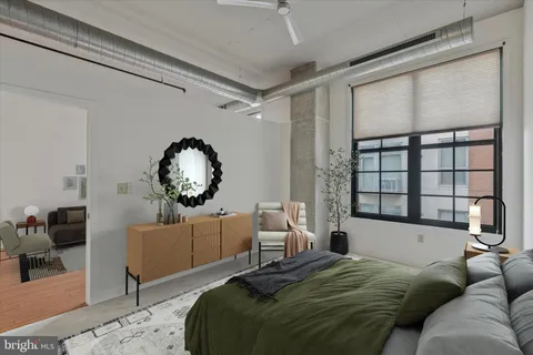 a bedroom with a large bed and a window