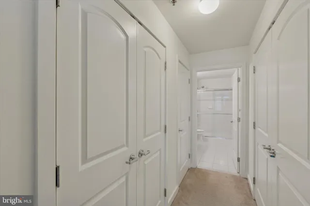 a bathroom with a granite countertop sink a toilet and shower
