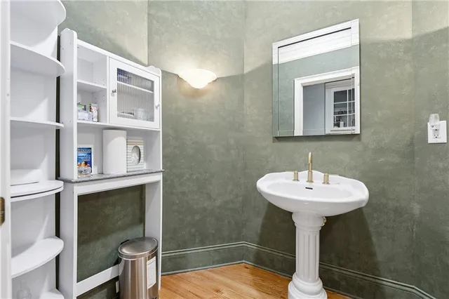 a kitchen with stainless steel appliances granite countertop a stove a sink and white cabinets