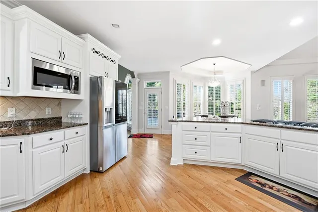 a bedroom with a bed wooden floor and window