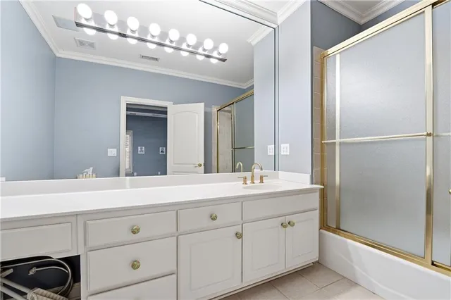 a view of an empty room with wooden floor and a ceiling fan