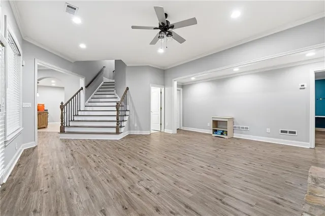 a room with pool table windows and wooden floor