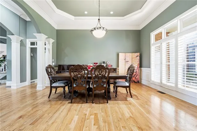 a view of a dining room with furniture and wooden floor