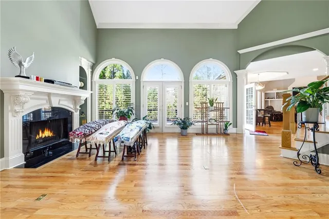 a living room with fireplace furniture and a large window