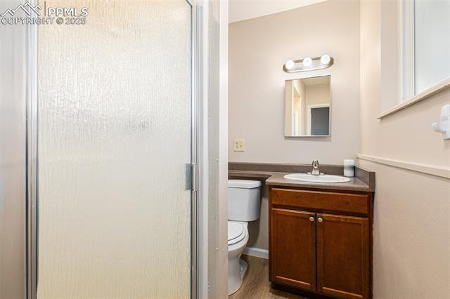 4514 Ridgeglen Road Colorado Springs, CO 80918 - Photo 22 of 29 Bathroom with a shower and vanity, and wood finished floors