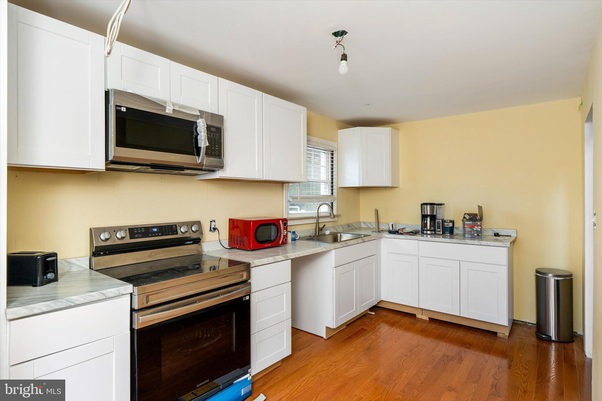 319 Station Road Roebling, NJ 08554 - Photo 5 of 15 a kitchen with stainless steel appliances a stove microwave and sink