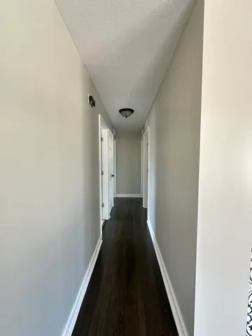 a view of a hallway with a wooden floor