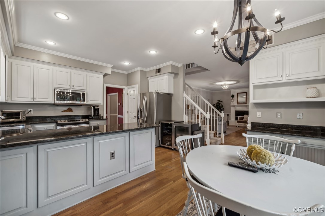 12802 Craystone Circle Midlothian, VA 23113 - Photo 16 of 50 a kitchen with stainless steel appliances granite countertop a stove a sink a refrigerator cabinets and living room view