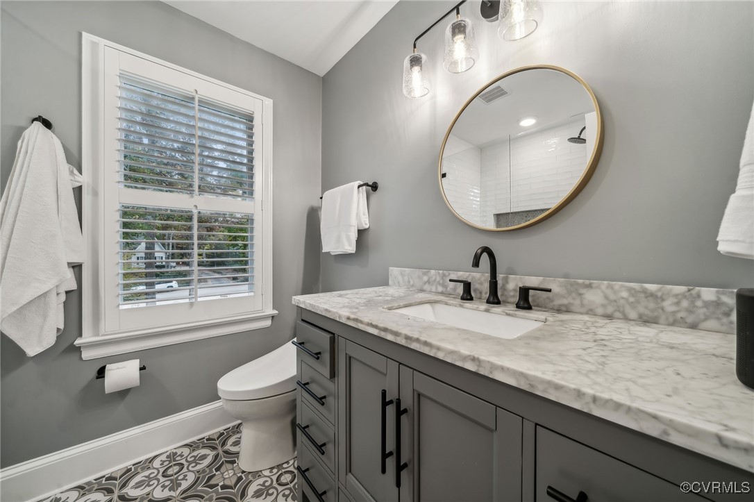 12802 Craystone Circle Midlothian, VA 23113 - Photo 34 of 50 a bathroom with a granite countertop toilet a sink and a mirror