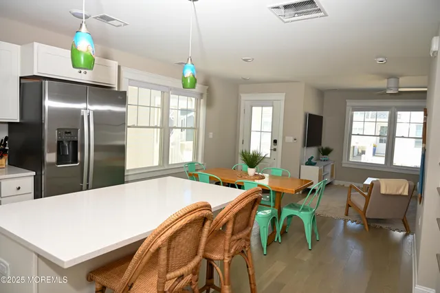 a very nice looking dining room with kitchen island furniture and a chandelier