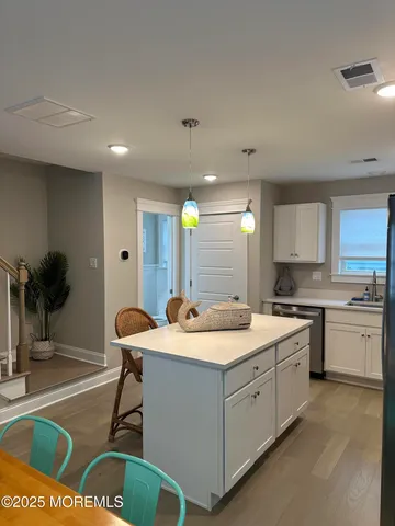 a kitchen with a sink appliances and cabinets