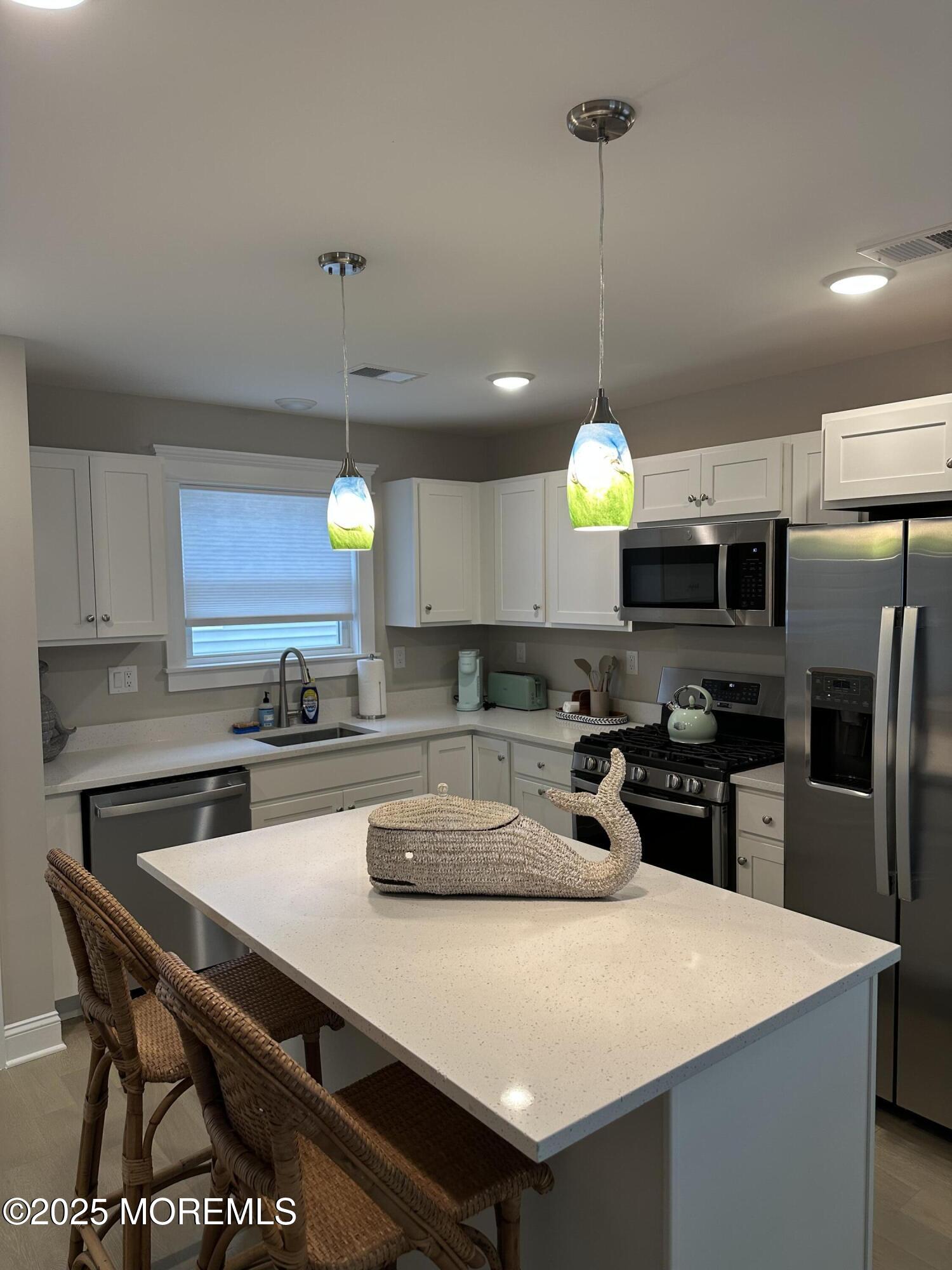 8 Shell Road Mantoloking, NJ 08738 - Photo 4 of 29 a kitchen with stainless steel appliances granite countertop a sink a stove and refrigerator