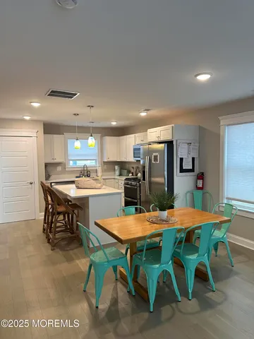 a kitchen with a table and chairs