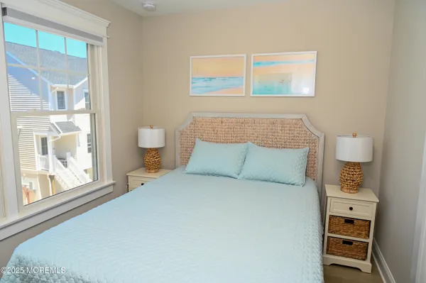 a large bed sitting in a bedroom next to a window