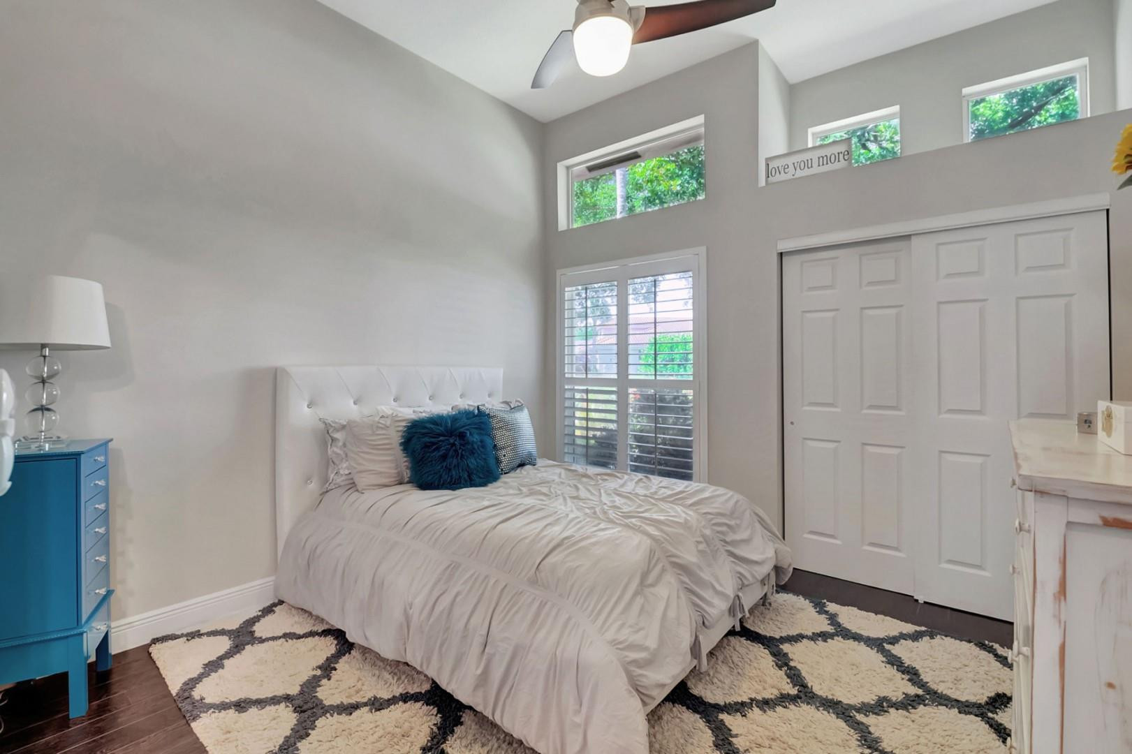 6096 Northwest 30th Way Boca Raton, FL 33496 - Photo 13 of 24 a bedroom with a bed and a window