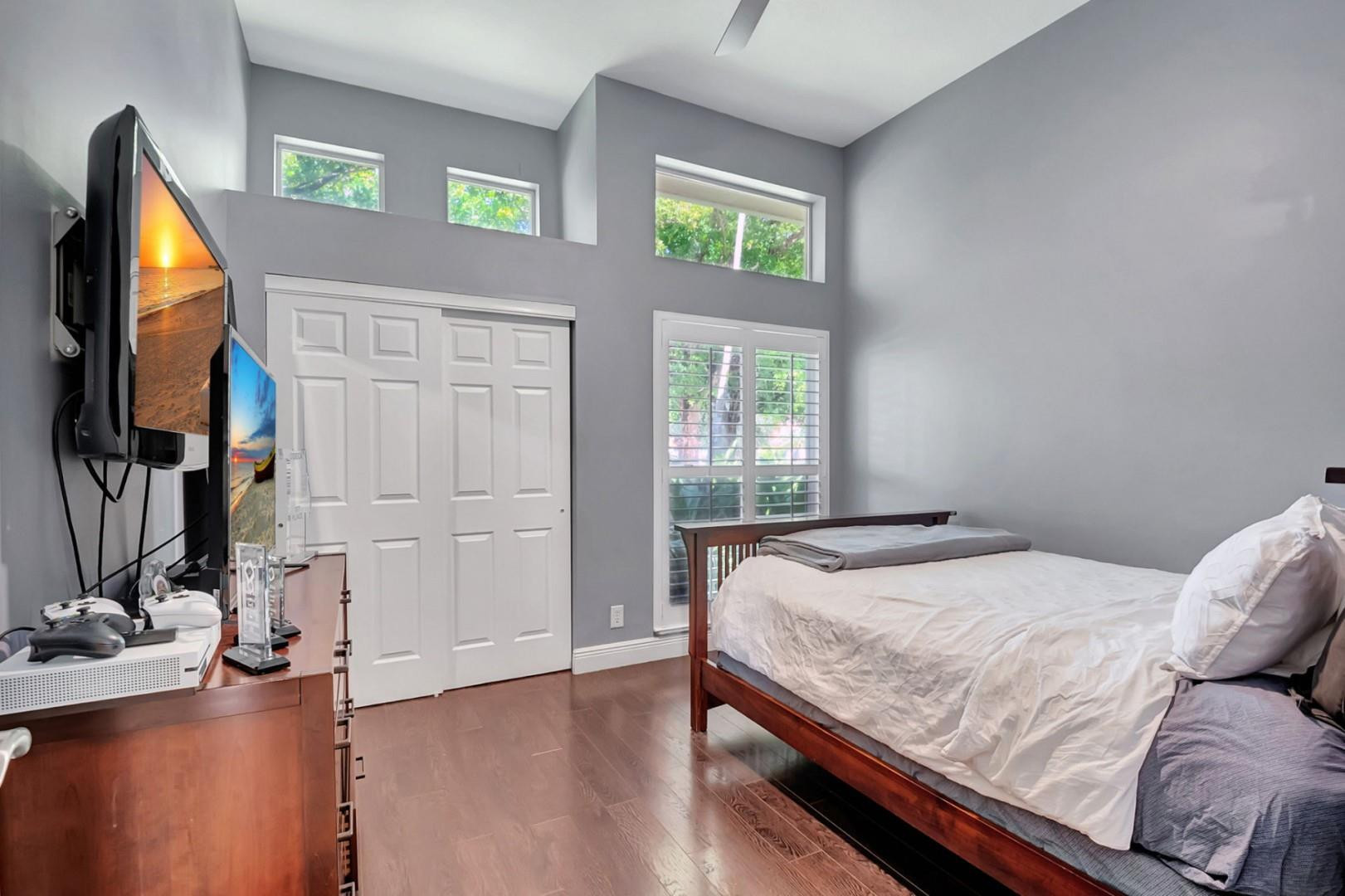 6096 Northwest 30th Way Boca Raton, FL 33496 - Photo 14 of 24 a bed sitting in a bedroom next to a window