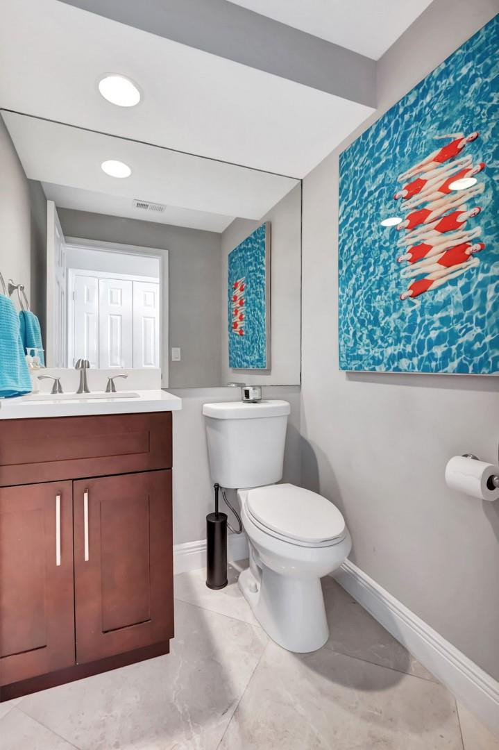 6096 Northwest 30th Way Boca Raton, FL 33496 - Photo 16 of 24 a bathroom with a sink a toilet and mirror