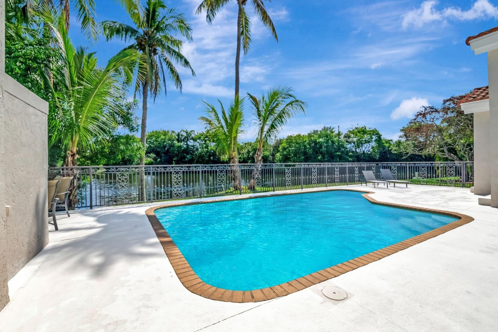6096 Northwest 30th Way Boca Raton, FL 33496 - Photo 18 of 24 a view of a swimming pool with a patio and a yard