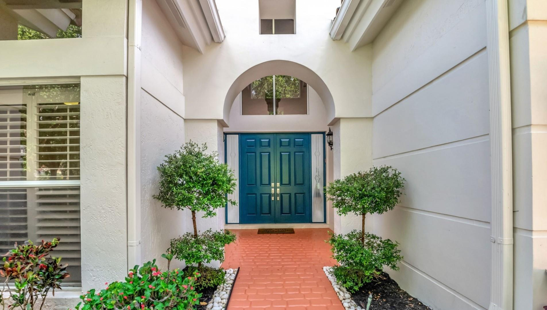 6096 Northwest 30th Way Boca Raton, FL 33496 - Photo 2 of 24 a front view of a house with garden